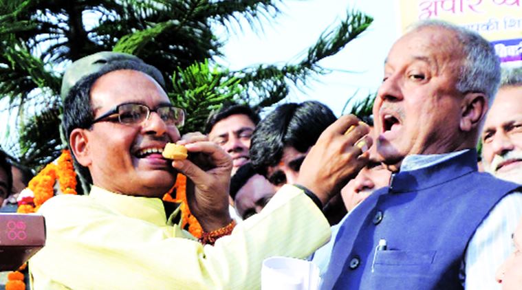 MP Chief Minister S S Chouhan celebrates with Maihar winner Narayan Tripathi. Express