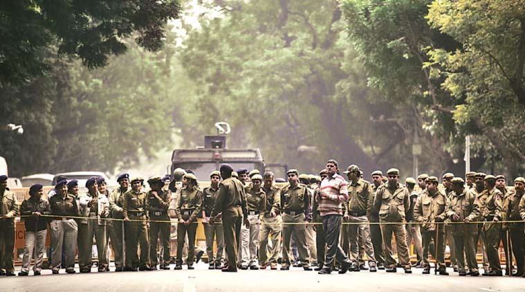 Delhi Police personnel at Parliament Street, minutes before hundreds of JNU students, teachers, artists and leaders marched into the area Thursday. (Express Photo Tashi Tobgyal)