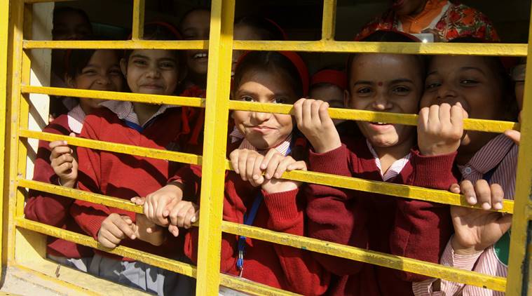 School children peep during Civil Defence Raising day celebration at N.P. Bengali sr.sec School gile market in new Delhi on Saturday in new Delhi .Express photo by Prem Nath Pandey/ 6th Dec. 2014