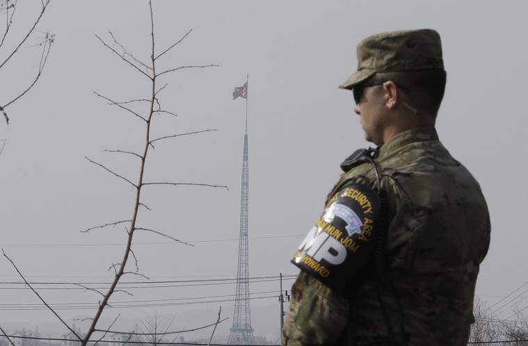 A North Korean flag flies in the propaganda village of Gijungdong as a US Army soldier stands guard at Taesungdong freedom village, South Korea. AP Photo