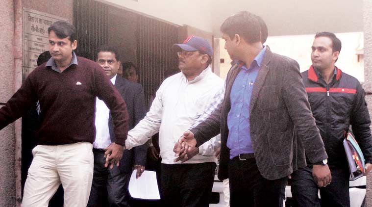 Yadav Singh (centre) being taken out of court by CBI Thursday. (Express Photo by: Purushottam Sharma)