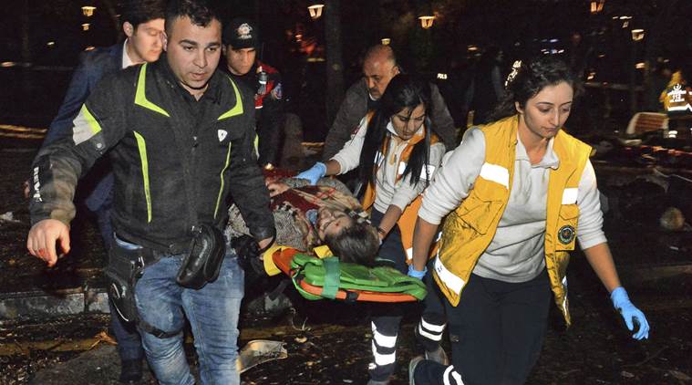 People carry an injured person after an explosion in the busy center of Turkish capital, Ankara, Turkey, Sunday, March 13, 2016. The explosion is believed to have been caused by a car bomb that went off close to bus stops. News reports say the large explosion in the capital has caused several casualties. (Selahattin Sonmez/Hurriyet Daily via AP) TURKEY OUT