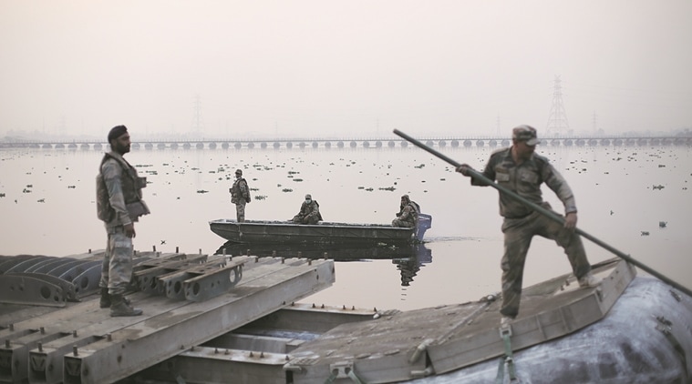 Military personnel transport an inflatable float meant for the pontoon bridge over Yamuna near the site of the World Culture Festival 2016 along the Yamuna flood plains on Tuesday (the pontoon bridge on the background was the first bridge constructed by the UP PWD for the event). Express photo by Oinam Anand