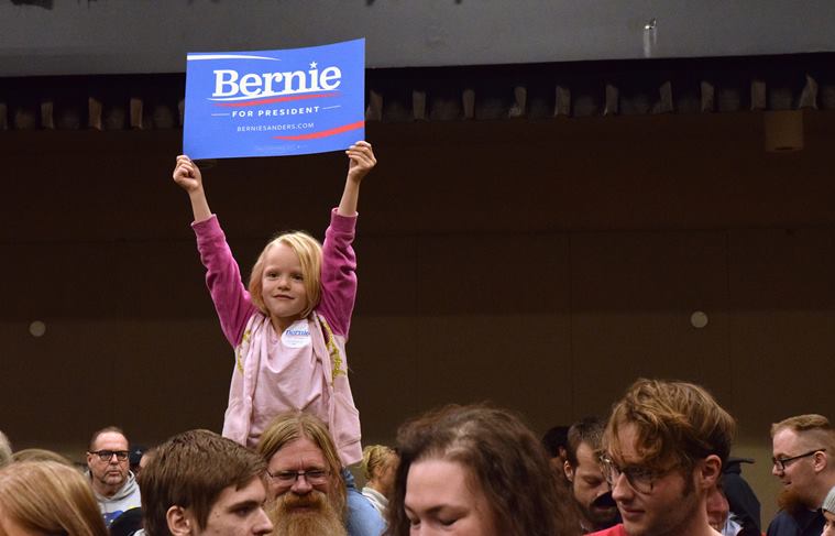 Five-year-old Courtney Skinner holds up a "Bernie Sanders for President" sign while sitting on Tom Skinner's shoulders at the Juneau Democratic Caucus on Saturday, March 26, 2016, in Centennial Hall's Sheffield Ballroom in Juneau, Alaska. Sanders won Democratic presidential caucuses in Alaska on Saturday, a victory he hopes will stoke a spring comeback against the commanding front-runner, Hillary Clinton. (James Brooks/The Juneau Empire via AP) MANDATORY CREDIT