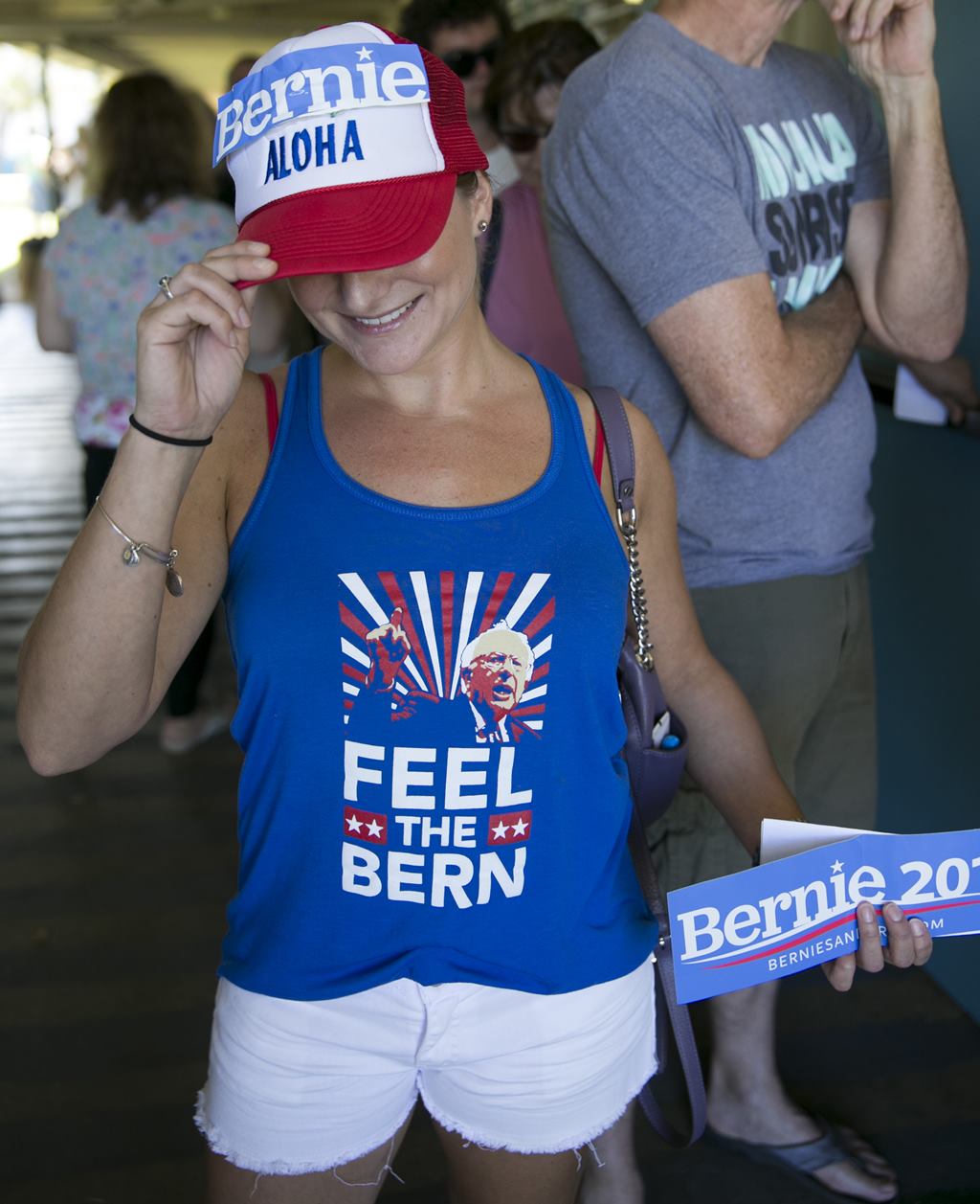Hawaii voter Noelle Giamblvo shows off her Bernie Sanders's swag while waiting in line at the Hawaii caucus at Kailua Intermediary School, Saturday, March 26, 2016, in Kailua, Hawaii. (AP Photo/Marco Garcia)