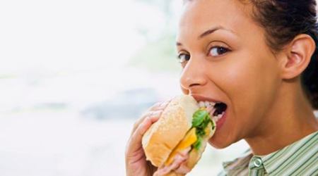 Woman eating sandwich