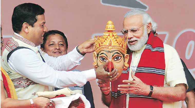 PM Modi with BJP’s CM candidate Sarbananda Sonowal  at Majuli in Assam Saturday. (Express Photo: Dasarath Deka)
