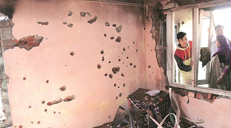villagers inspect a damaged house during a gunbattle in Dadsar, Tral outskirts of Srinagar. Three Militants killed in a gunbattle with security forces early Thursday Express Photo 03-03-2016