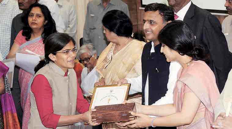 Richa receives Rani Laxmi Bai Award from CM Akhilesh Yadav, wife Dimple in Lucknow, Tuesday. (Express Photo: Vishal Srivastav)