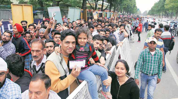 Kumood Sharma with wife Rohini and daughter Prisha. Sharma took leave from office, Prisha from school to queue up. (Express Photo: Jasbir Malhi)