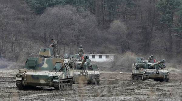 South Korean army soldiers stand on their K-55 self-propelled howitzers during an annual exercise in Paju, near the border with North Korea, Monday, March 7, 2016. North Korea on Monday issued its latest belligerent threat, warning of an indiscriminate "pre-emptive nuclear strike of justice" on Washington and Seoul, this time in reaction to the start of huge U.S.-South Korean military drills. (AP Photo/Ahn Young-joon)