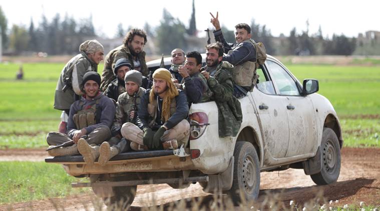 Rebel fighters from 'Jaysh al-Sunna' gesture as they ride a vehicle in Tel Mamo village, in the southern countryside of Aleppo, Syria March 6, 2016. REUTERS/Khalil Ashawi