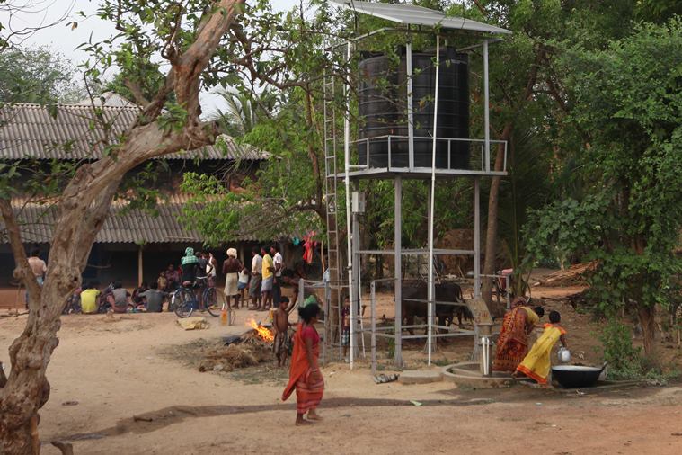 On feast day at Bara pelia village, there's meat after a successful hunt, but water from the newly installed water tank isn't fit for drinking or cooking and water must be brought from nearby village.Express Photo/Partha Paul.