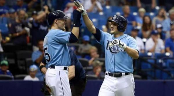Oct 4, 2015; St. Petersburg, FL, USA; Tampa Bay Rays left fielder Mikie Mahtook (27) is congratulated by Tampa Bay Rays left fielder Brandon Guyer (5) as he hits a 2-run home run during the first inning against the Toronto Blue Jays at Tropicana Field. Mandatory Credit: Kim Klement-USA TODAY Sports