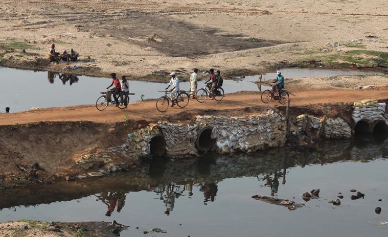 Villagers of Lalgarh cross a dry riverbed after a hunting festival. Partha Paul/Express Photo