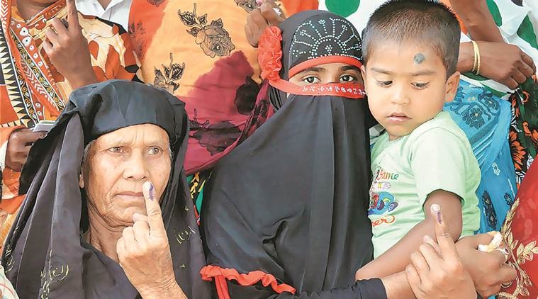 Nagaon: Muslim women showing their ink marked fingers after casting votes during the state assembly elections in Nagaon, Assam on Monday. PTI Photo