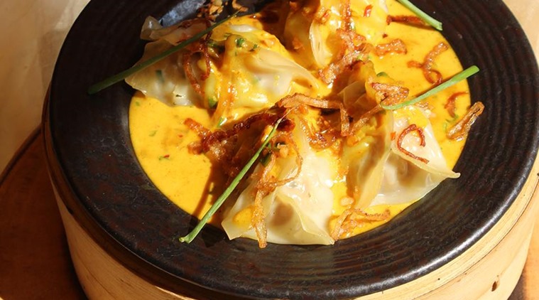 A dish of Burmese samosas, which are chicken samosas on a bed of Burmese curry, is the star of Cress Bistro's dimsum menu in Delhi.