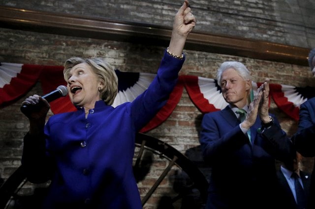 Democratic U.S. presidential candidate Hillary Clinton speaks to a gathering of Irish American supporters as her husband former U.S. president Bill Clinton applauds at a campaign in the Manhattan borough of New York City, April 18, 2016. REUTERS/Mike Segar