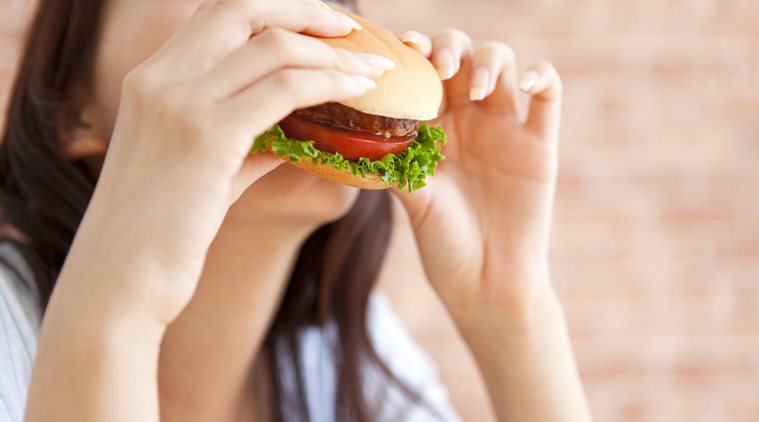 Young woman eating a hamburger