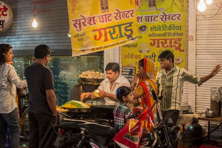 A chaat vendor serves his clientele.