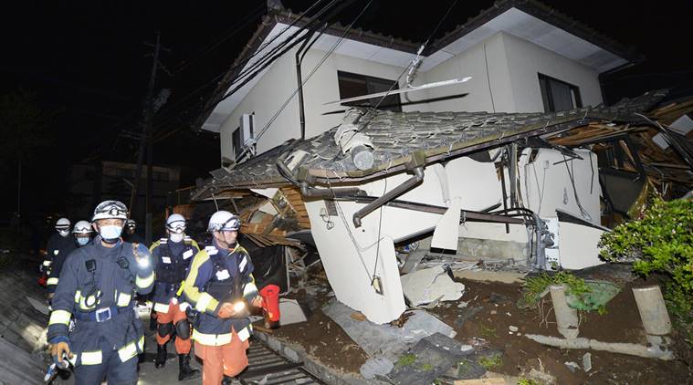 Firefighters check the damage of the collapsed house in Mashiki, near Kumamoto city, southern Japan, after the earthquake early Friday, April 15, 2016. (Source: AP)