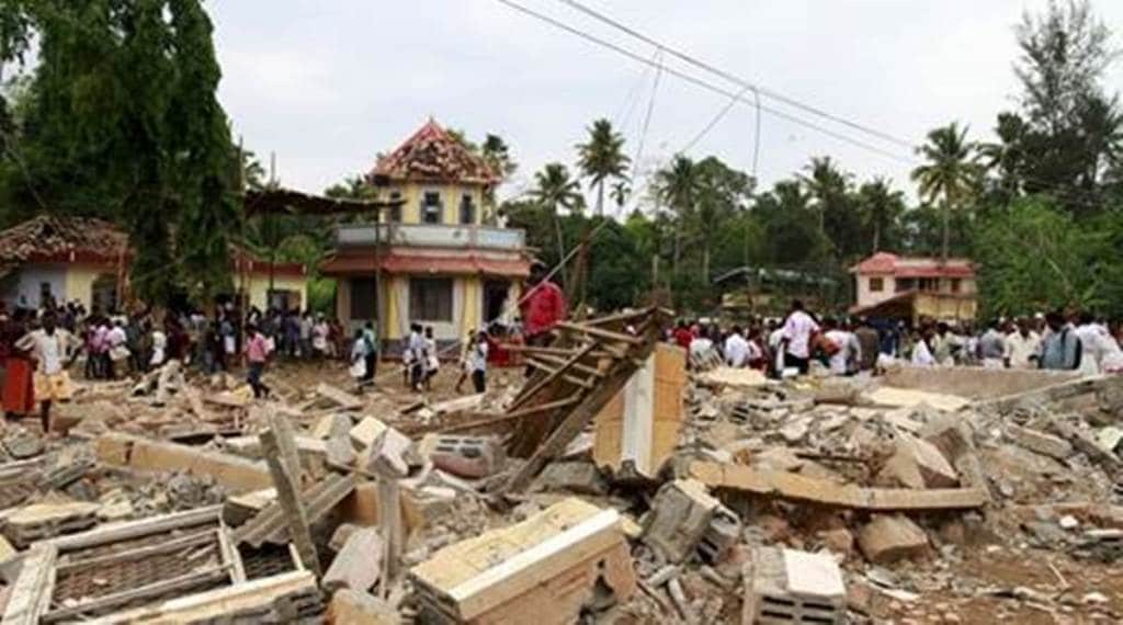 People walk past debris after a fire broke out at a temple in Kollam in the southern state of Kerala, India, April 10, 2016. A huge fire swept through a temple in India's southern Kerala state early on Sunday (April 10), killing nearly 80 people and injuring over 200 gathered for a fireworks display to mark the start of the local Hindu new year. REUTERS/Sivaram V