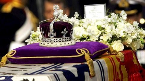 In this April 5, 2002 file photo, The Koh-i-noor, or "mountain of light," diamond, set in the Maltese Cross at the front of the crown made for Britain's late Queen Mother Elizabeth, is seen on her coffin, along with her personal standard, a wreath and a note from her daughter, Queen Elizabeth II, as it is drawn to London's Westminster Hall. AP/PTI