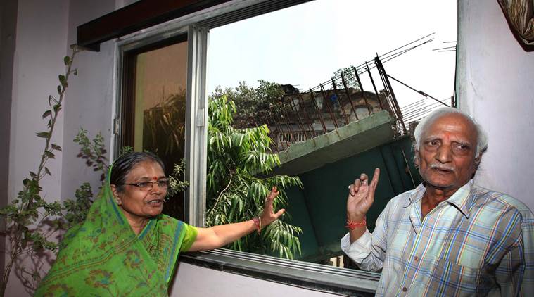 Gayatri devi Nagnolia (66) and Shiv Kumar Nagnolia (72) check out the crash site from their window. (Express photo by Partha Paul)