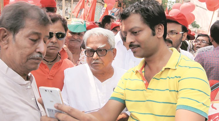 A supporter clicks a selfie with Biman Bose in Kashba on Sunday. Express photo