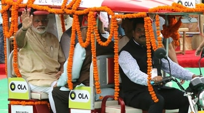 Narendra Modi rides in an e-rickshaw during ‘Stand up India’ launch ...