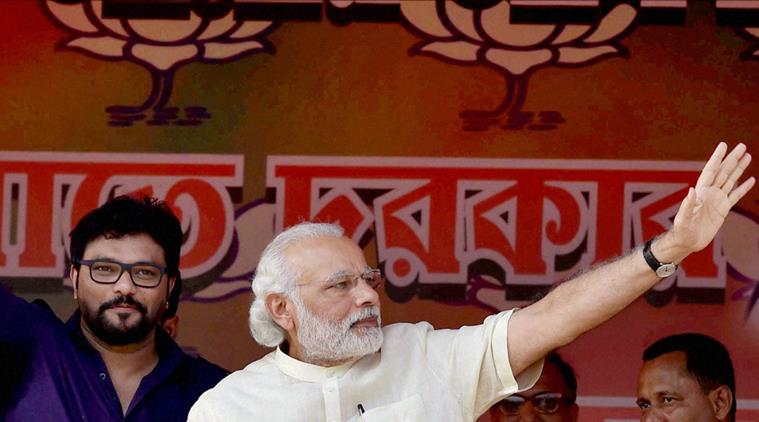 Asansol: Prime Minister Narendra Modi and Union Minister Babul Supriyo waving hands towards people during an election rally in support of BJP candidate, in Asansol on Thursday. PTI Photo by Swapan Mahapatra(PTI4_7_2016_000228B)