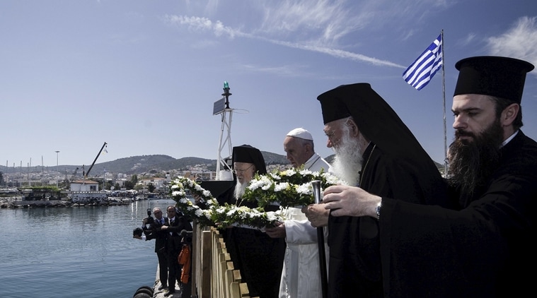 Pope Francis, Archbishop Ieronimos (front) and Greek Orthodox Ecumenical Patriarch Bartolomew I (back) prepare to throw flower wreaths in the sea in memoriam of the refugees that lost their lives in their effort to reach Europe, during the Pope's visit on the Greek Island of Lesbos aiming at supporting refugees and drawing attention to the front line of Europe's migration crisis in Lesbos in this handout photo released by the Greek Prime Minister's press office, April 16, 2016. REUTERS/Andrea Bonetti/Greek PM Press Office/Handout via Reuters ATTENTION EDITORS - THIS PICTURE WAS PROVIDED BY A THIRD PARTY. REUTERS IS UNABLE TO INDEPENDENTLY VERIFY THE AUTHENTICITY, CONTENT, LOCATION OR DATE OF THIS IMAGE. EDITORIAL USE ONLY. NOT FOR SALE FOR MARKETING OR ADVERTISING CAMPAIGNS. NO RESALES. NO ARCHIVE. THIS PICTURE IS DISTRIBUTED EXACTLY AS RECEIVED BY REUTERS, AS A SERVICE TO CLIENTS