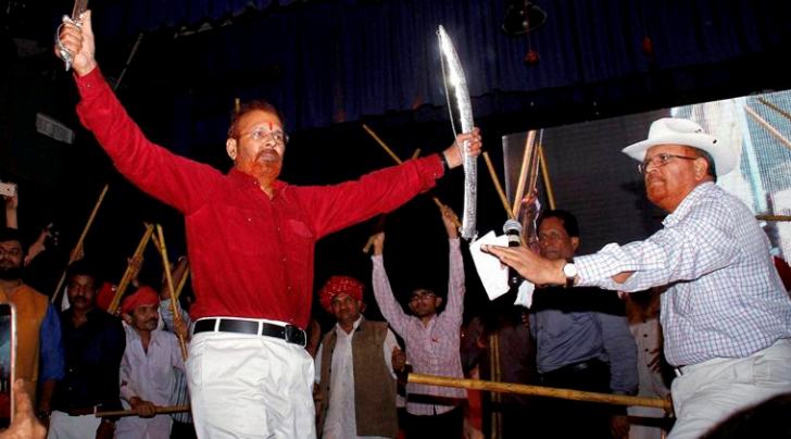 Retired IPS officer D G Vanzara dances with a sword during a welcome ceremony by his community in Gandhinagar on Friday. PTI Photo 
