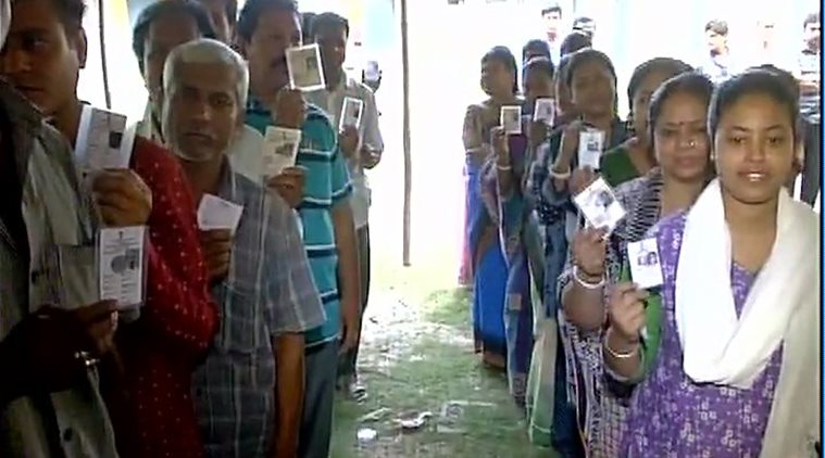 Voters line up outside a polling booth in Malda. ANI photo