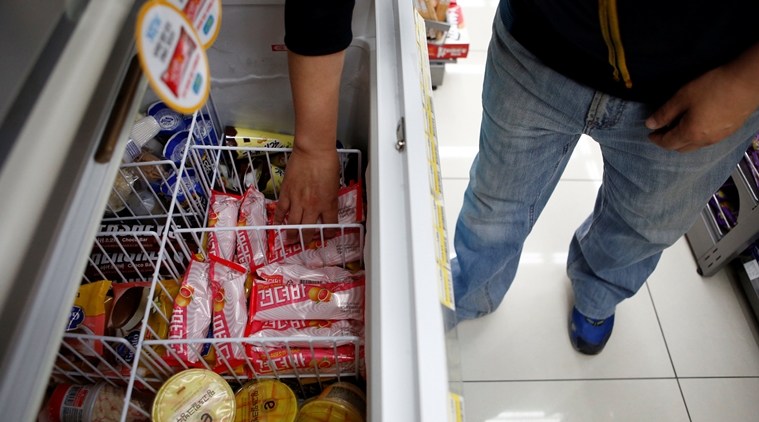 A clerk arranges ice cream bars named Gyeondyo-bar, which translates to "hang in there" at a convenience store in Seoul, South Korea, May 20, 2016. REUTERS/Kim Hong-Ji