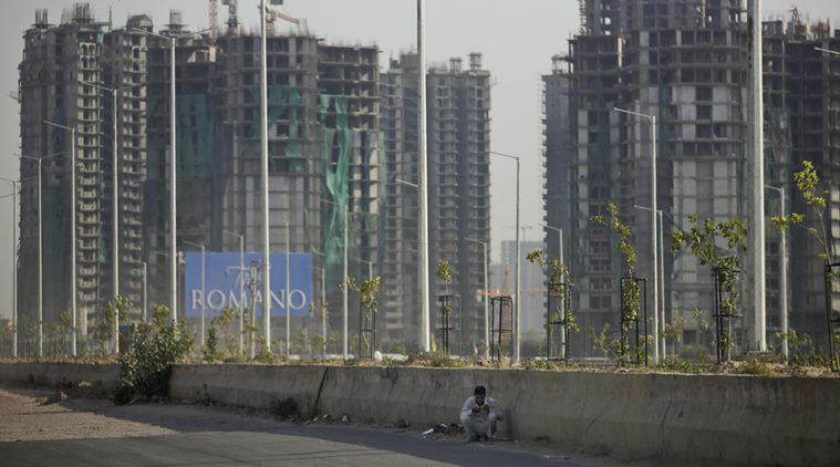 An Indian buffalo herder sits in the shade of a road divider as his cattle graze in a field on the other side of the road on a hot afternoon in New Delhi, India, Wednesday, May 18, 2016. Scorching summer temperatures, hovering well over 40 degrees Celcius, (104 Fahrenheit) are making life extremely tough for millions of poor across north India. Without access to air conditioning and sometimes even an electric fan, they struggle to cope with the heat in their inadequate homes. (AP Photo/Altaf Qadri)