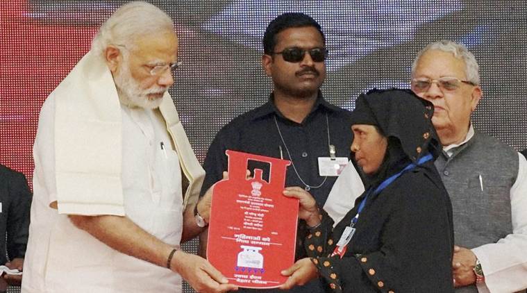 Ballia: Prime Minister Narendra Modi presents cooking gas connection to a woman of Below Poverty Line (BPL) family during a launch of "Pradhan Mantri Ujjwala Yojana" in Ballia on Sunday. PTI Photo(PTI5_1_2016_000053A)