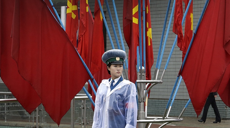 A North Korean traffic police woman stands in front of Workers' Party flags decorating the streets on Friday, May 6, 2016, in Pyongyang, North Korea. North Korea has been duly spruced up, the masses prepped for their rallies and leader Kim Jong Un appears to be set to take center stage Friday when North Korea pulls back the curtain on what promises to be the country's biggest political show in years, if not decades: the first full congress of its ruling party since 1980. (AP Photo/Wong Maye-E)