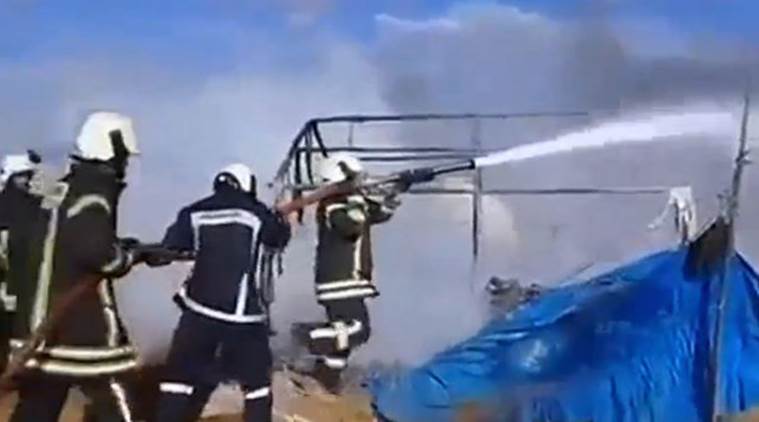 Firemen douse burnt tents at a camp for internally displaced people near Sarmada in Syria's Idlib province in this undated still image taken from video on May 6, 2016. Social Media ATTENTION EDITORS - THIS PICTURE WAS PROVIDED BY A THIRD PARTY. EDITORIAL USE ONLY. REUTERS IS UNABLE TO INDEPENDENTLY VERIFY THIS IMAGE. NO RESALES. NO ARCHIVE.