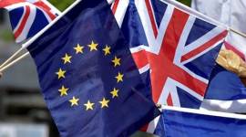 British students hold the UK Union flags and European Union flags in front of the European Parliament in Brussels David cameron, France, Britain, Britain France, Cameron aide, Ed Llewellyn, news, UK news, britain news, world news, international news, France news