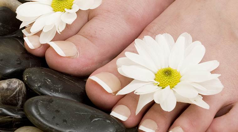 Woman's feet in bowl of water and rocks