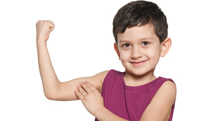 A smiling boy is showing the results of morning exercises