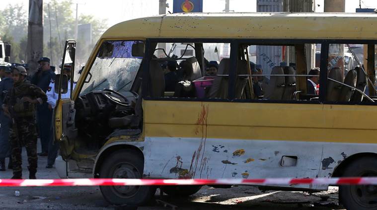 Afghan security forces inspect the damage of a minibus that was hit by a suicide attacker at the site of the incident in Kabul, Afghanistan June 20, 2016. REUTERS/Omar Sobhani