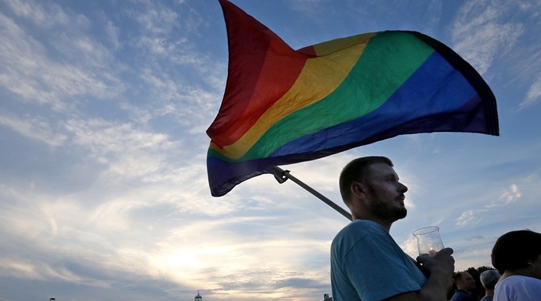 Gabriel Swaidner of Gulfport holds a rainbow flag during a vigil near the lighthouse to honor the victims of the mass shooting in Orlando, Monday, June 13, 2016, in Biloxi, Miss. A gunman killed dozens of people in a massacre at a crowded gay nightclub in Orlando on Sunday, making it the deadliest mass shooting in modern U.S. history. (John Fitzhugh/The Sun Herald via AP) LOCAL TELEVISION OUT; MANDATORY CREDIT: MISSISSIPPI PRESS OUT; LOCAL TELEVISION OUT WLOX, LOCAL ONLINE OUT; GULFLIVE.COM OUT