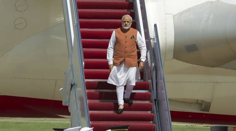 Indian Prime Minister Narendra Modi walks down the stairs from his plane upon his arrival at Andrews Air Force Base, Md., Monday, June 6, 2016. Modi in a three-day visit to Washington, will meet with President Barack Obama and will address a joint meeting of the U.S. Congress. (AP Photo/Jose Luis Magana)