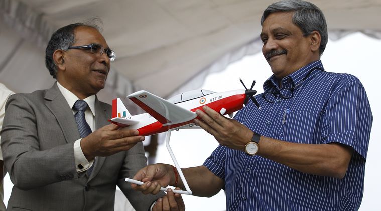 Indian Defence Minister, Manohar Parrikar, receives a model of indigenous prototype trainer aircraft, HTT-40 (Hindustan Turbo Trainer 40), from Chairman of Hindustan Aeronautics Limited, T. Suvarna Raju, in Bangalore, India, Friday, June 17, 2016. (AP Photo/Aijaz Rahi)