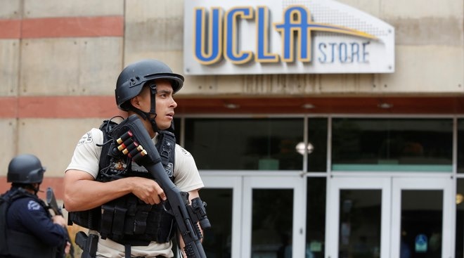 A Los Angeles Metro Police officer stands watch on the University of California, Los Angeles (UCLA) campus after it was placed on lockdown following reports of a shooter in Los Angeles