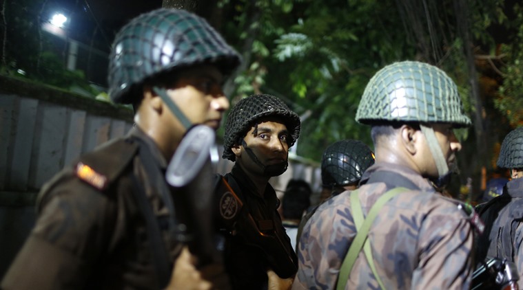 Bangladeshi security personnel stand guard near a restaurant that has reportedly been attacked by unidentified gunmen in Dhaka, Bangladesh, Friday, July 1, 2016. Local media reported that a group of attackers took hostages inside a restaurant frequented by both locals and foreigners in a diplomatic zone in Bangladesh's capital. (AP Photo)