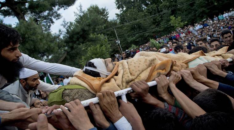 Kashmiri villagers display the body of Burhan Wani, chief of operations of Indian Kashmir's largest rebel group Hizbul Mujahideen, during his funeral procession in Tral, some 38 Kilometers (24 miles) south of Srinagar, Indian controlled Kashmir, Saturday, July 9, 2016. Indian troops fired on protesters in Kashmir as tens of thousands of Kashmiris defied a curfew imposed in most parts of the troubled region Saturday and participated in the funeral of the top rebel commander killed by Indian government forces, officials and locals said. (AP Photo/Dar Yasin)