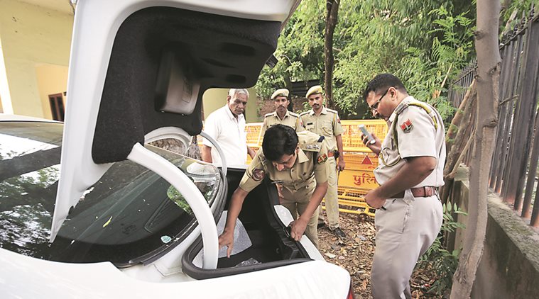 Police officers inspect the car, Saturday. (Source: Rohit Jain Paras)